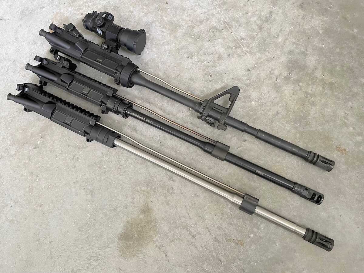 Carbine, mid-length and rifle-length AR-15 uppers stacked to compare gas tube lengths