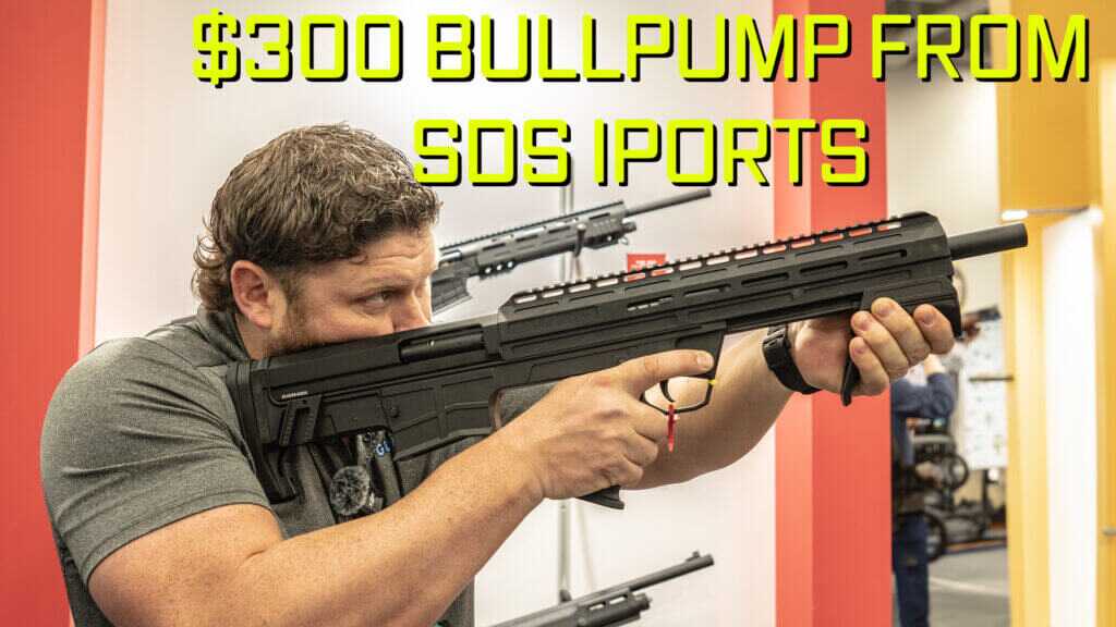 True Holding the SDS Bull Pump shotgun.