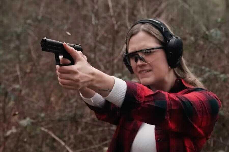 A woman shooting the Keltec P57