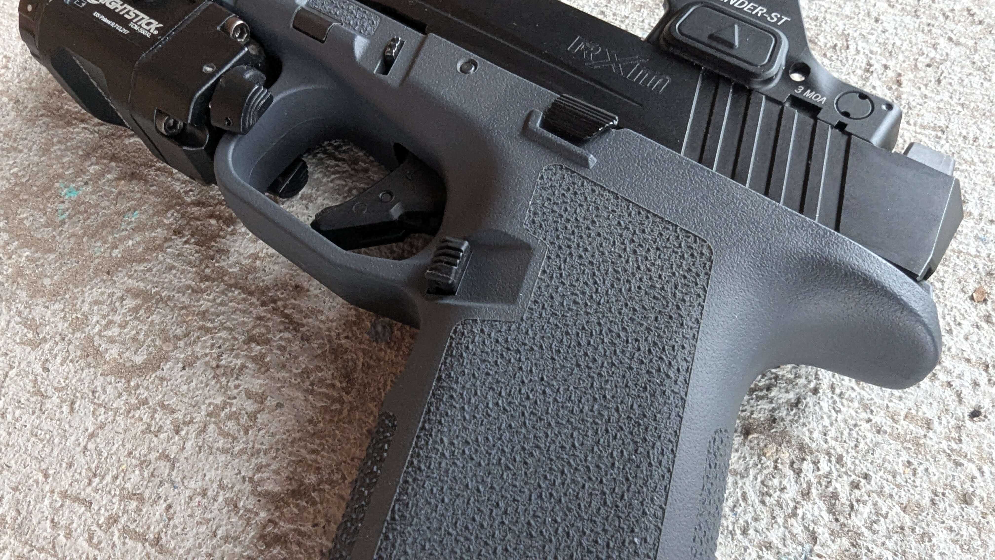 Scalloped magazine release area on the Ruger RXM grip