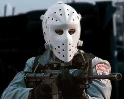 HEAT man in white plastic face mask holding gun