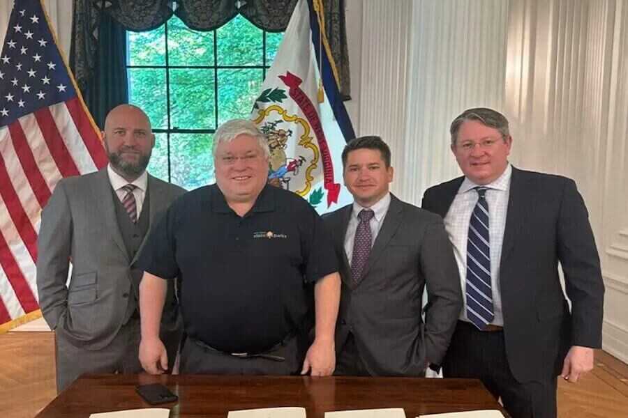 Four men standing after the signing of the bills.