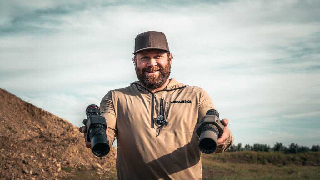 man holding two spottind scopes