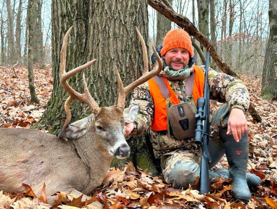 hunter and buck in the forest