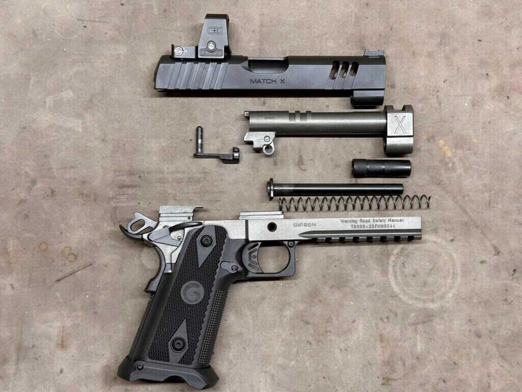 A disassembled handgun is laid out on the tan tabletop.Witness2311 Match X