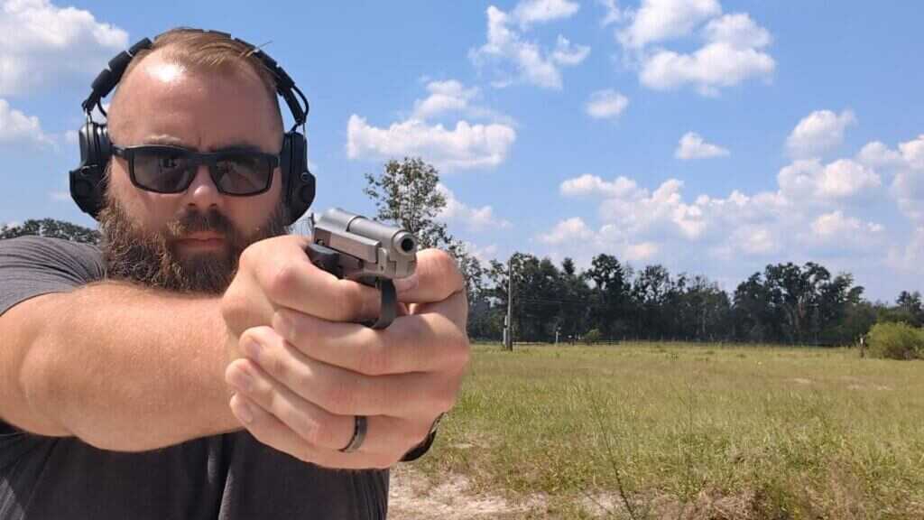 Aiming the Beretta 21A illustrating tiny sights and control issues