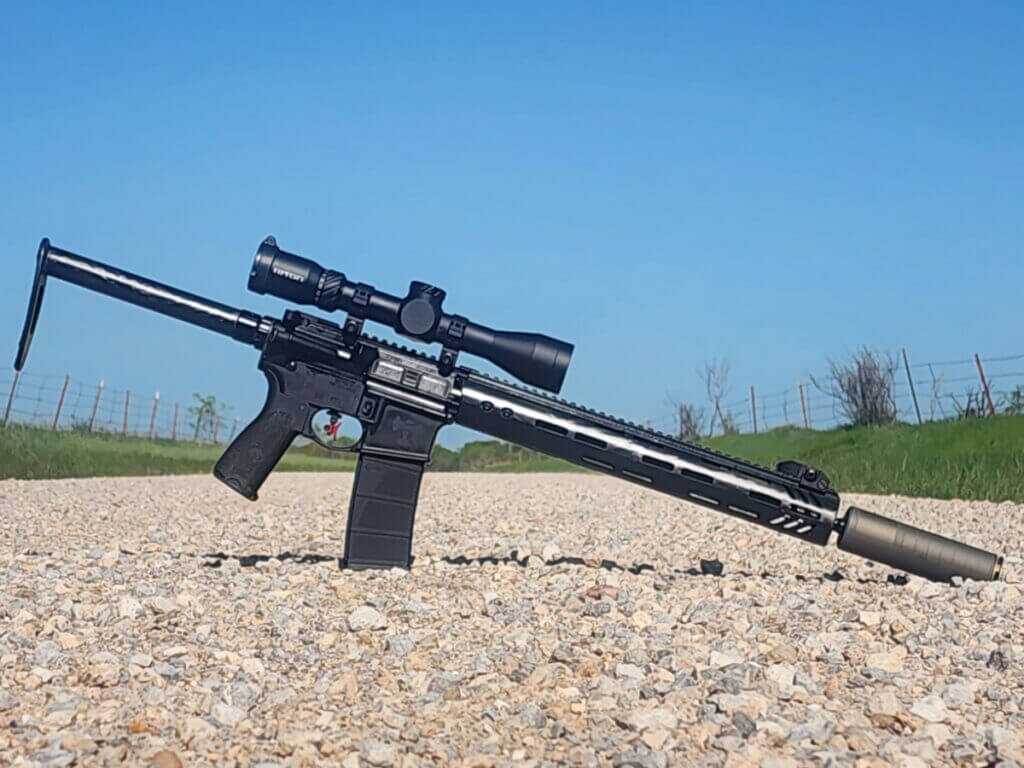 SilencerCo Scythe Ti mounted on rifle, multi-caliber titanium suppressor for .223 to .300 RUM