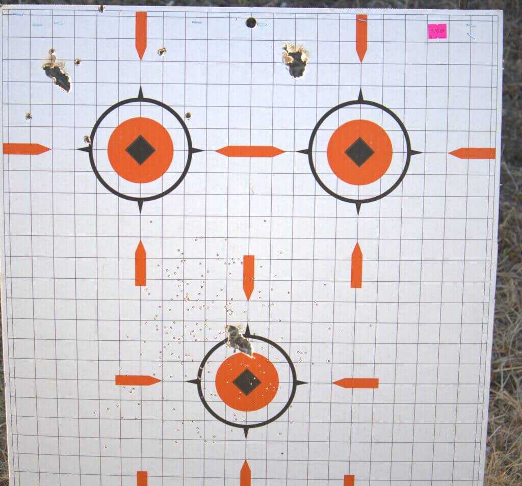 Charles Daly Honcho shotgun patterns at twenty feet on white board with orange targets