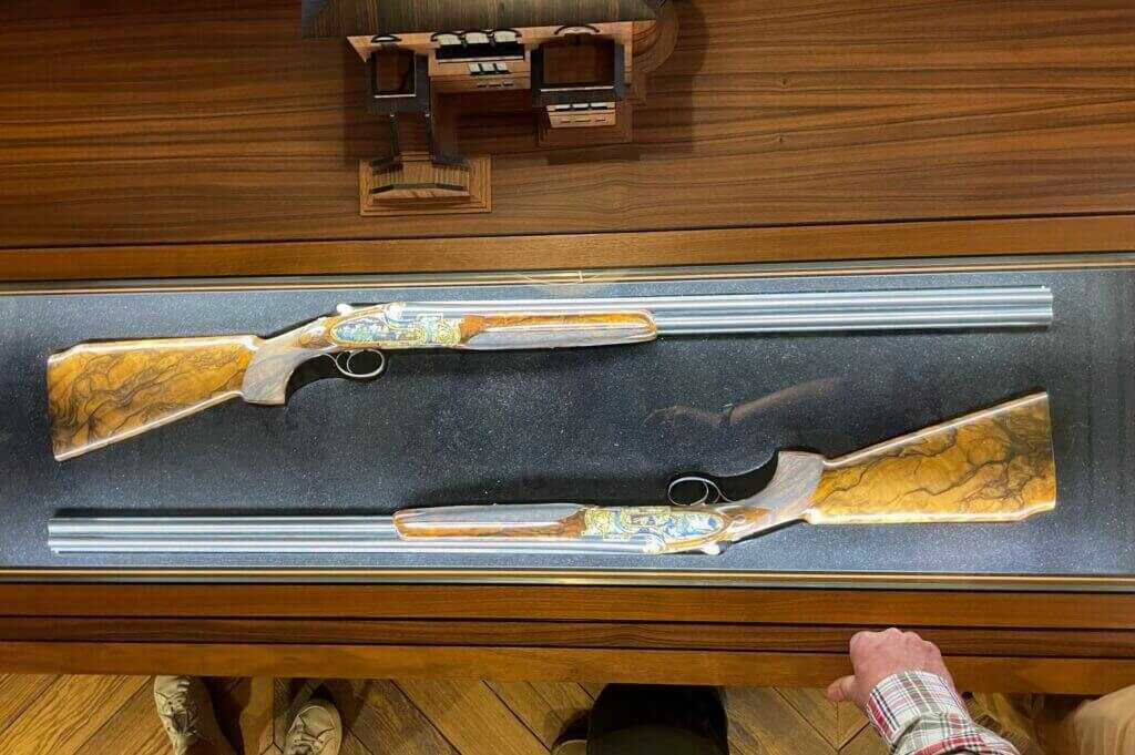 Matched pair of Beretta 12 gauge shotguns engraved and inlaid with multi color gold