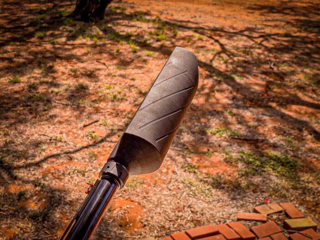 Silencer Central Banish 12 shotgun suppressor side profile showing half can design