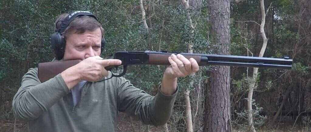 Shooter firing Winchester Model 94 in .30 30 at range