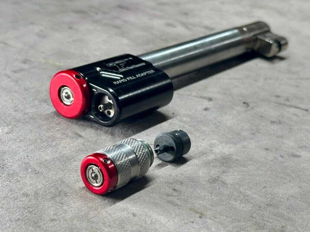 CoolFire Trainer barrel with laser modules including Rapid Fill Adapter Laser on tabletop