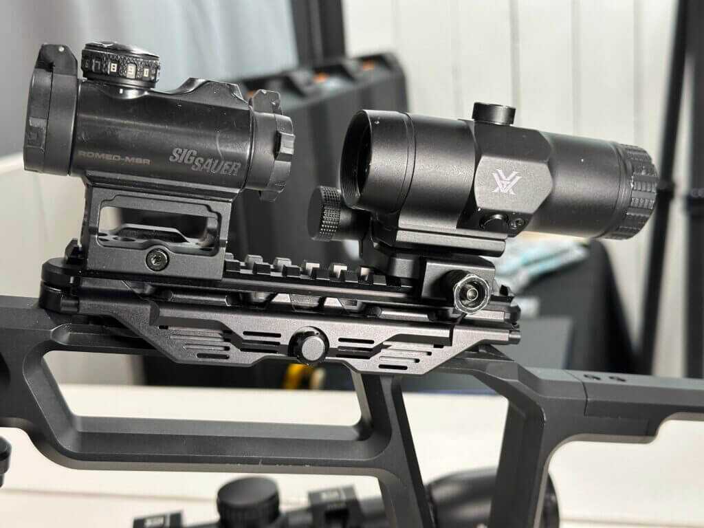 The optic mount on this display firearm now has a red dot and magnifier attached to it.