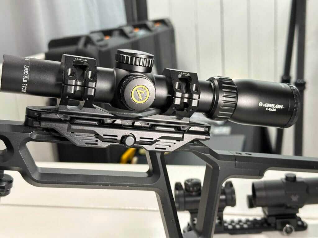 A rifle scope is mounted on a fake rifle for display.