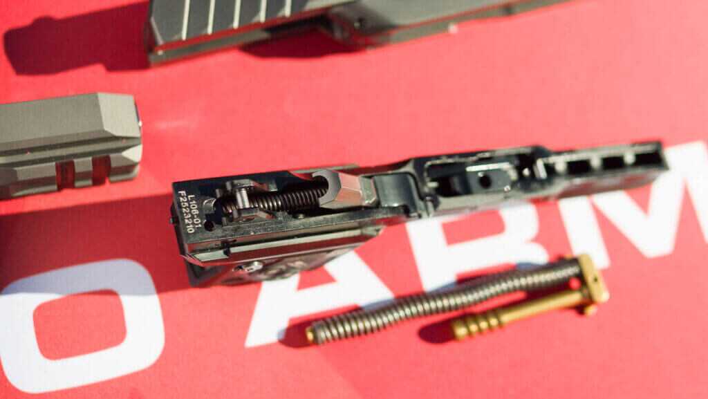 the top rail, upside down on a table showing the hammer.