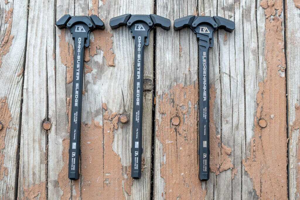 Two new Breek Arms Omni-Buster charging handles beside the original Sledgehammer for AR-15 suppressor gas comparison