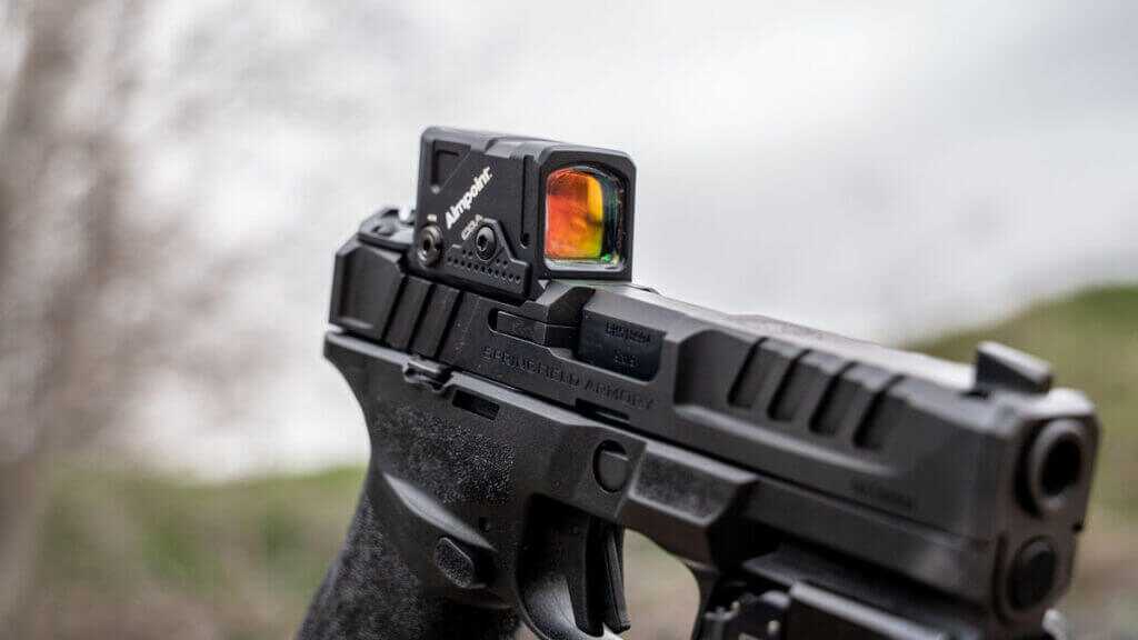 Close view of the Aimpoint COA enclosed emitter optic mounted low on the Springfield Echelon slide with A-CUT interface