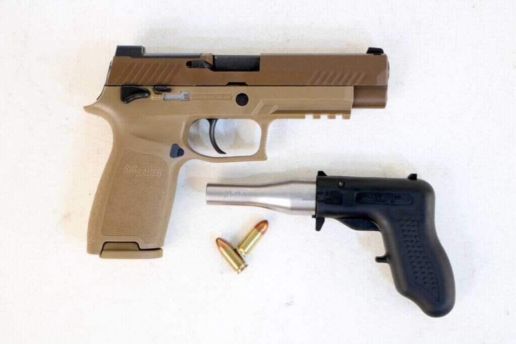 Altor 9mm pistol beside a SIG M17 showing its tiny size and limited combat practicality
