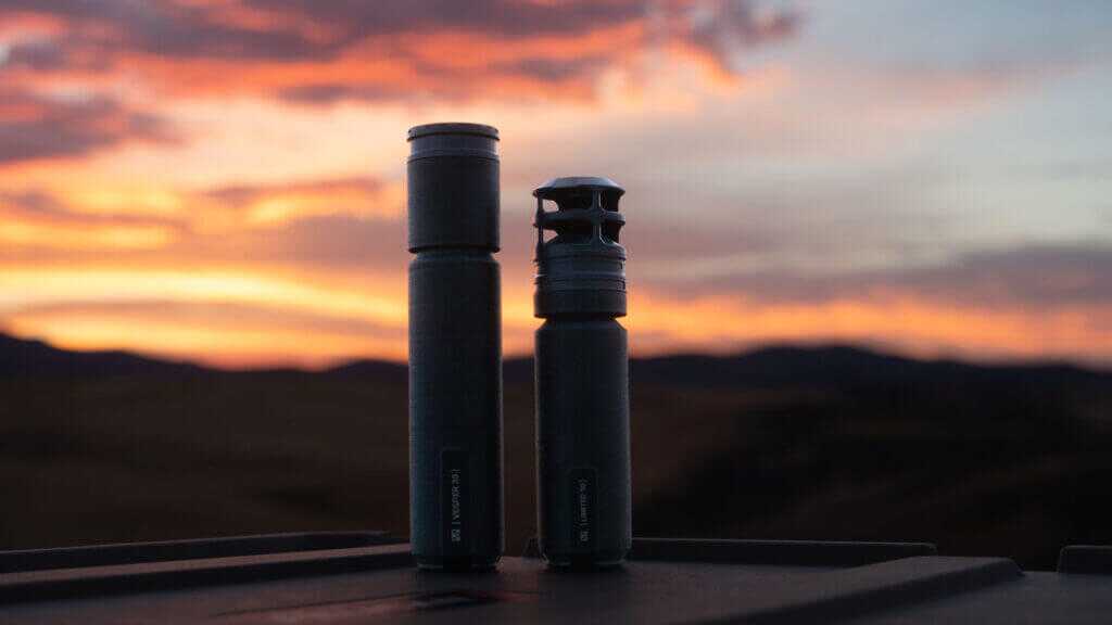 Tenet Vesper suppressor muzzle beside a Limited 30 fitted with the Tenet Horizon Brake