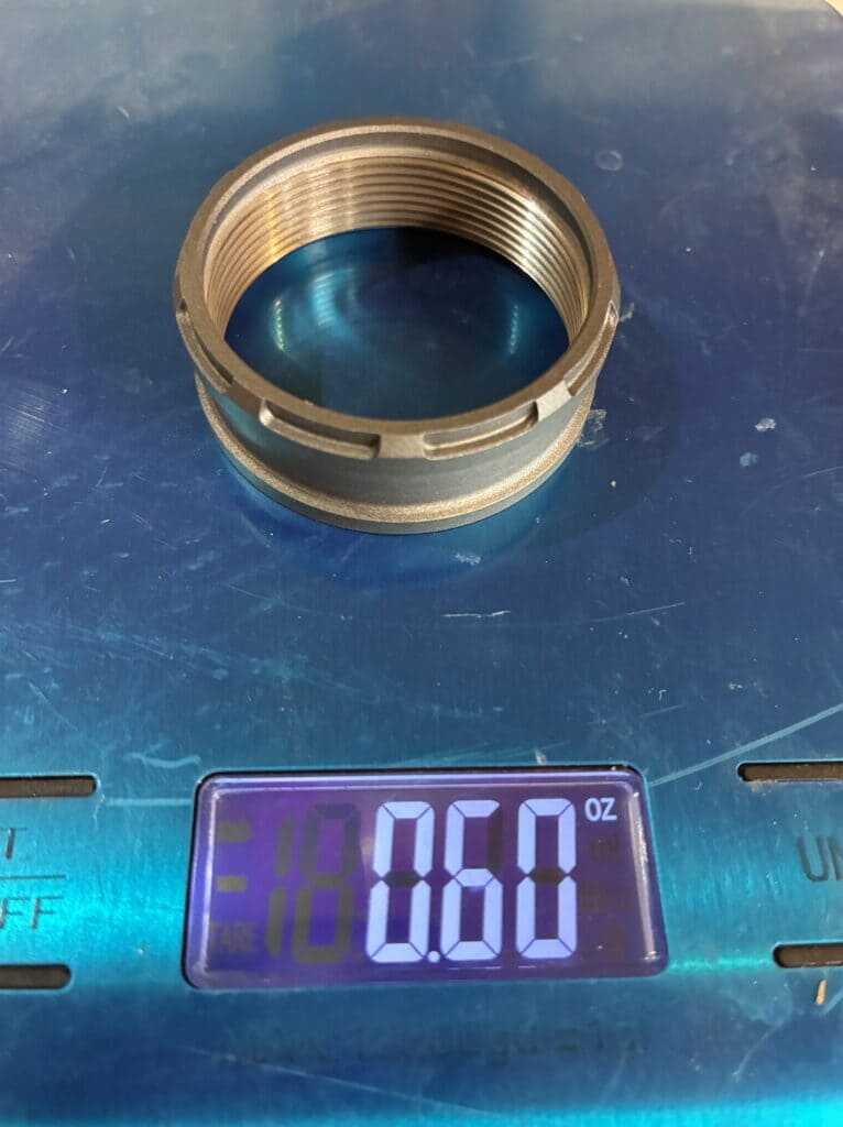 Tenet Vesper 6.5 thread protector weighing .6 oz on a digital scale