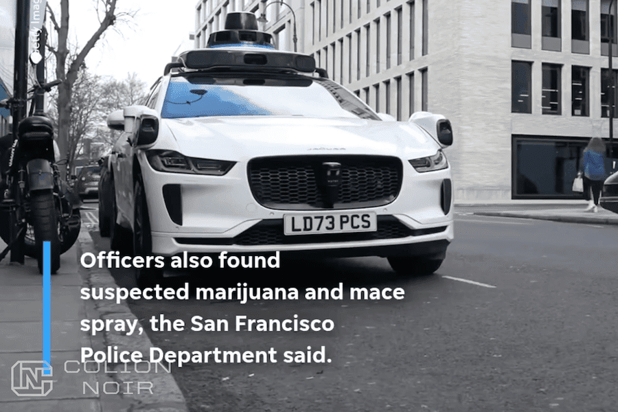 White Jaguar equipped with autonomous-driving sensors on a city street, shown in Colion Noir’s video.