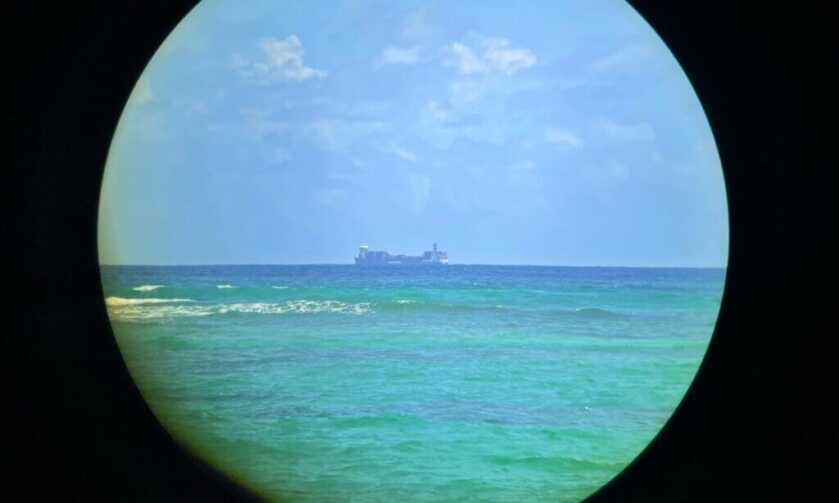 Distant shipping vessel viewed through Vortex Triumph 10x28 HD binoculars showing image clarity and edge distortion