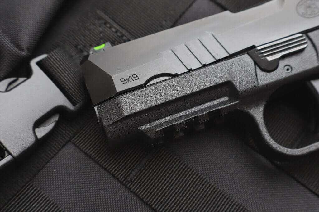 FN 309 MRD slide, muzzle, cocking serrations, and Picatinny accessory rail