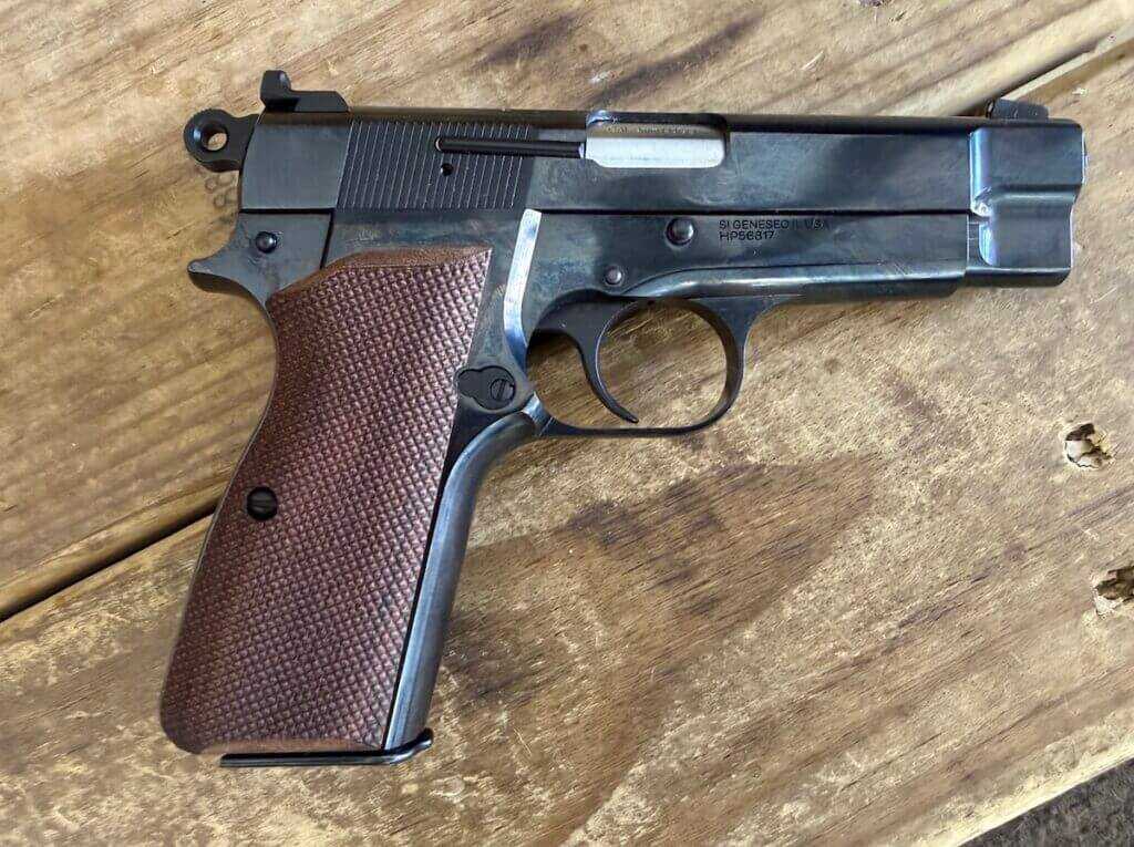 Springfield SA-35 4 inch Polished pistol showing glossy blue finish and checkered walnut grips