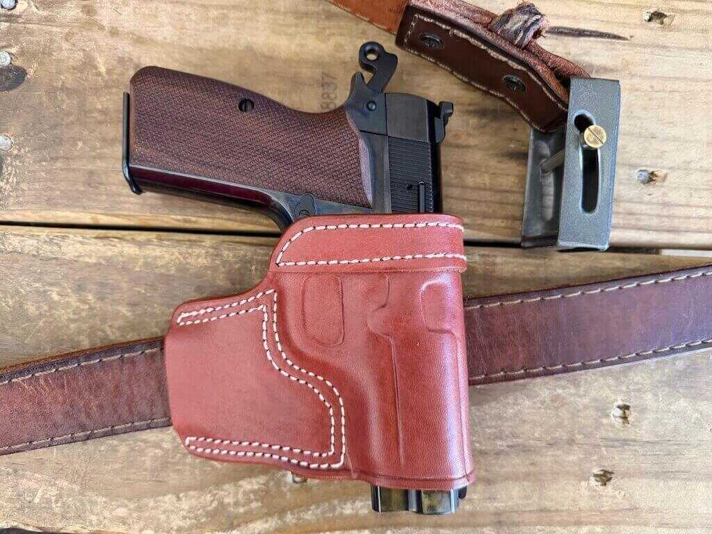 Springfield SA-35 4 inch Polished carried in old-school minimalist leather holster