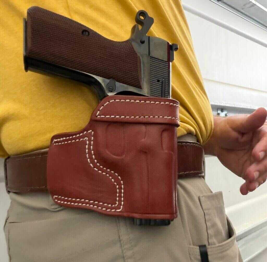 Springfield SA-35 4 inch Polished review pistol seated in minimalist leather holster