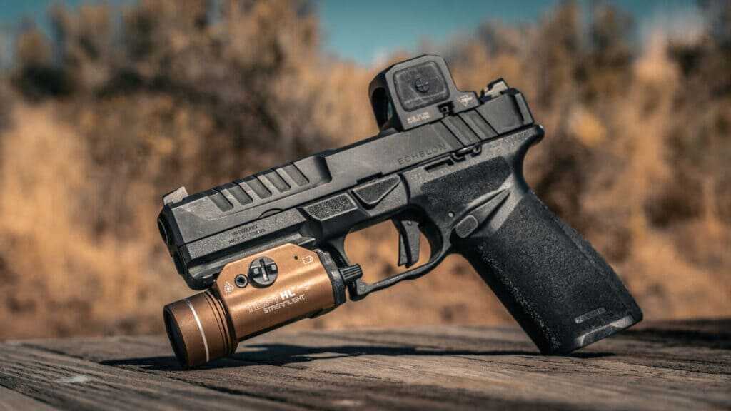 Original Springfield Echelon 9mm pistol equipped with a weapon light and slide-mounted red dot optic for comparison with the Echelon Pro