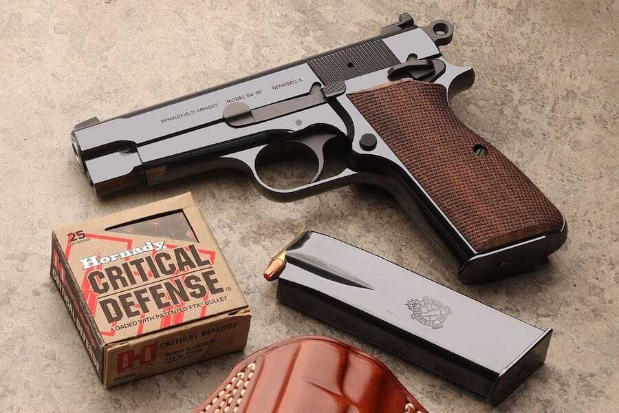 Springfield Armory 4-inch Polished Blued SA-35 pistol with walnut grips, magazine and defensive ammunition.
