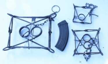 Prepping 101: Killer Traps These are three sizes of Conibear, or "killer" traps, with their mainsprings folded in. The one of the left is the 330 size, and the 110 and 160 are on the right, with the AK mag in there for a size reference.