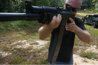 The long magazine holds more, but it requires a bit of practice. It is easy to see how it can limit range of motion.