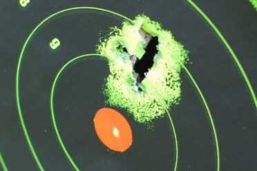 Note the red dot on the red dot. Out of the box it shoots a little high from 15 yards, but 7 rounds in one hole make up for that. 