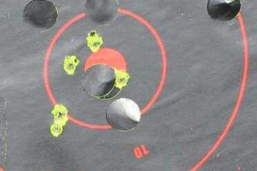 Henry's .22 Magnum Small Game Exterminators Five from 100. The group spread out, but this is from rimfire with peep sights, and is damn solid shooting.