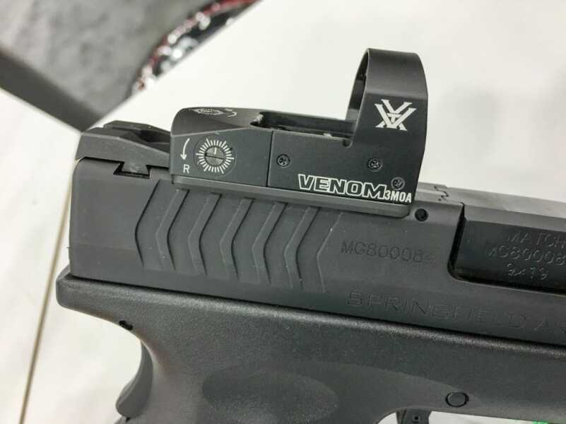 The slide is milled to accept mounting plates to fit different optics designs.