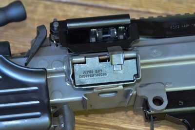 The M249S magazine port features a self-closing dustcover/door that closes when a magazine is not inserted.