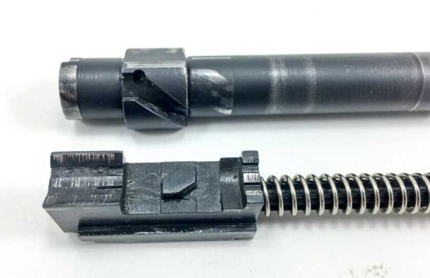 Here you can see how the central block (below) engages the barrel groove (above).