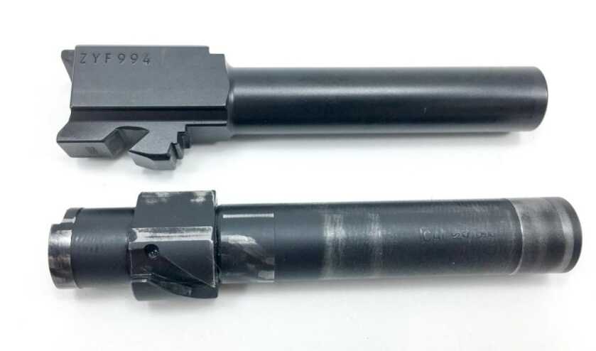 The groove in the Beretta PX4 barrel (bottom) causes rotation of the barrel during recoil.