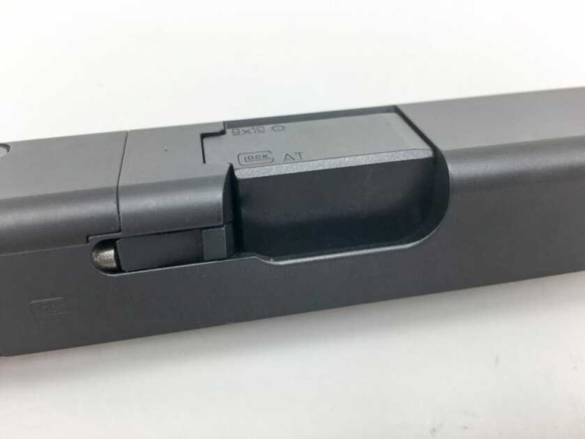 Many semi-automatic pistols, like this Glock 19, lock via fit between a square portion of the barrel hood and the ejection port.