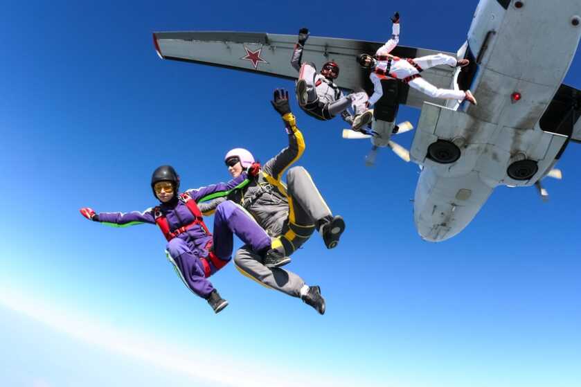 A group of paratroopers jumping out of an airplane.