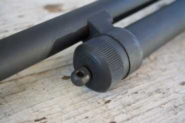 The magazine tube end cap has a swiveling sling attachment point.