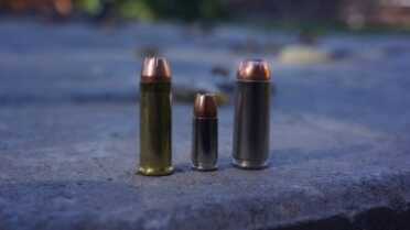 The .50 AE cartridge (right), next to a 9mm (center) and a .44 Mag. (left).