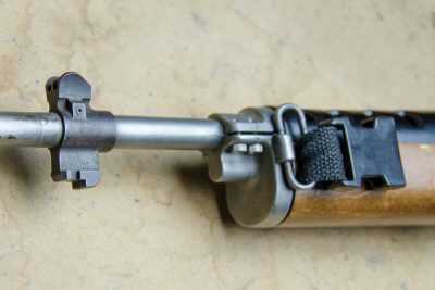 There some aftermarket options out there, but the original Ruger AC-556's have the sling swivel on the left side of the gas block.
