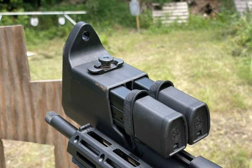 Folding 9mm Carbine! Smith & Wesson M&P FPC Reviewed The double mag carrier integrated in the stock of the FPC with the quick release locking mechanism sticking up from the bottom