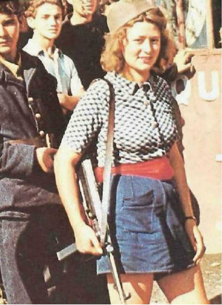 Simone Segouin holding a gun color photo
