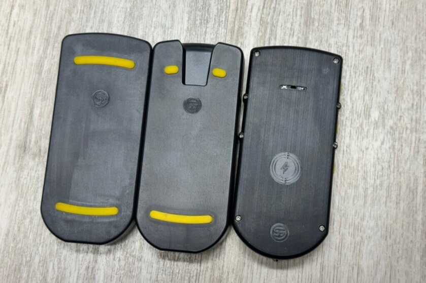 3 - Train With Purpose: Shooters Global Shot Timer Review U-Grip holders. Left is the original, the middle one is what currently ships with the timers, and on the right is the timer itself with the buzzer microphone slit in the top middle.
