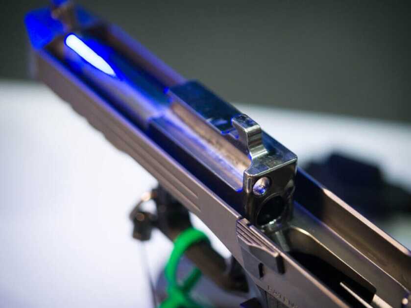 Close up view of the barrel with the slide removed. The gun is pointing away and left.