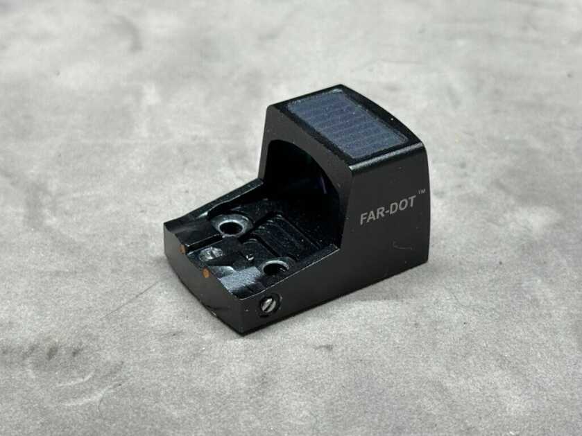 Closeup of a pistol-mounted red dot sight.